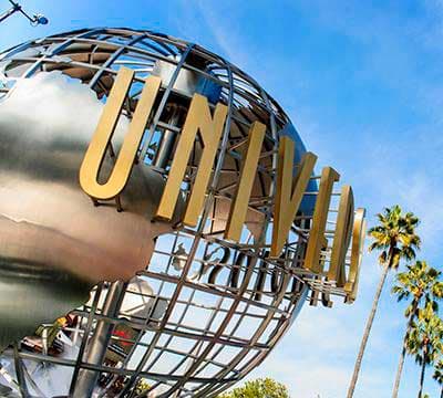 The iconic Universal Studios globe with its golden 'UNIVERSAL' lettering against a blue sky.